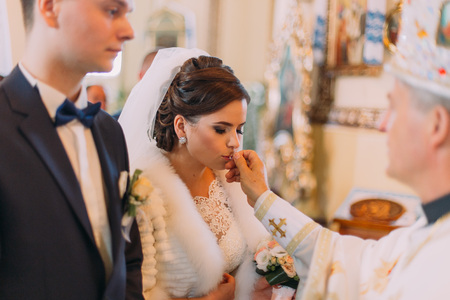The close-up view of the beautiful bride kissing the wedding ring.の写真素材