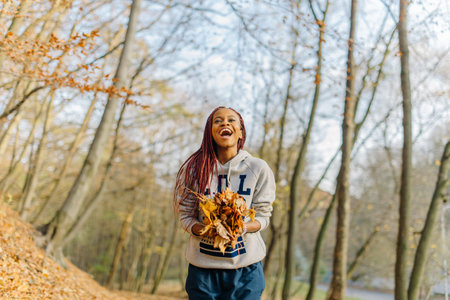 Adorable african american mixed race girl wearing sport clothes playing in park with bunch of...
