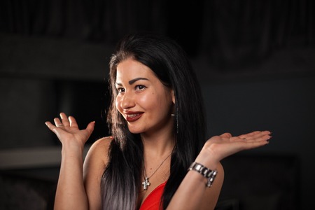 Pretty woman posing for camera with funny face.の写真素材