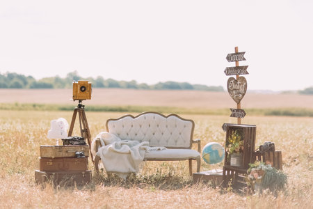 The composition of the old-fashioned sofa with the knitted plaid, wooden plaques with the signs...