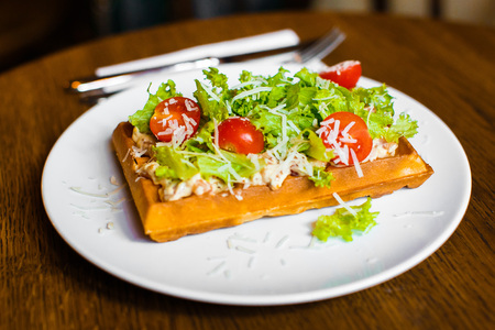 The side photo of the vegetable belgian waffles with tomatoes, salat and cheeseの写真素材