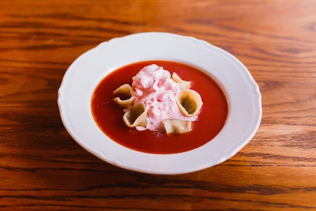 The side view of the borsch(red soup), dumplings decorated with sour creamの写真素材