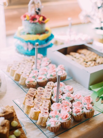 Lovely decorated cupcakes with colourful freshcream in the form of rosesの写真素材