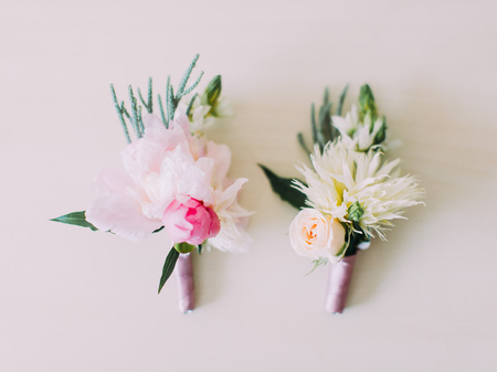 Lovely boutonnieres made of colourful roses and exotic flowersの写真素材