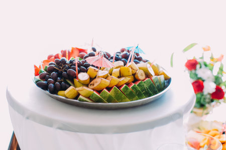 The plate full of different fruits. Wedding table set