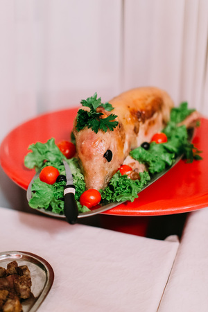 The dish consisted of the smoked pig with different vegetables. Wedding table setの写真素材