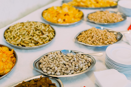 The plate full of pistachios on the wedding table setの写真素材