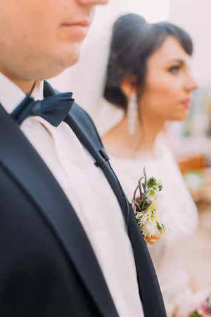 The side view of the boutonniere of the exotic flowers on the facket of the groomの写真素材