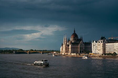 Panorama view of swimming boats along River Danube near the Budapest Parliament and Chain Bridge. Budapest, Hungary location.のeditorial素材