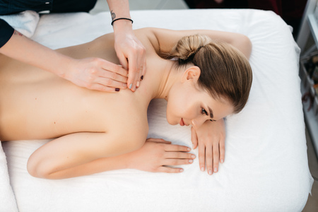 Above view of the slim attractive woman resting during the massage in spa salon. Skin care.の写真素材