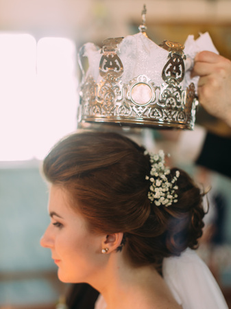 The side close-up portrait of the bride during the wedding coronation.の写真素材