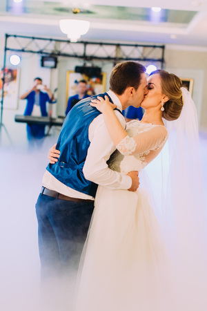Close-up side portrait of the kissing just marrid in the smoke.の写真素材