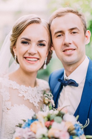 Close-up portrait of the smiling newlywed couple.の写真素材