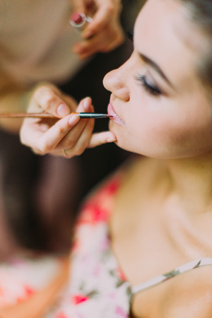 Close-up view of the hand of the artist doing the make-up for the bride.の写真素材