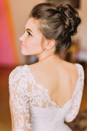 The bare back of the beautiful bride with wonderful hairdo.の写真素材