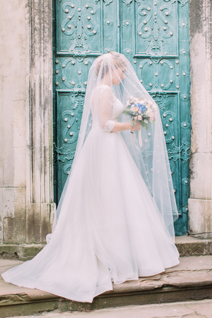 The look of the stylish bride with the bouquet under the veil.の写真素材