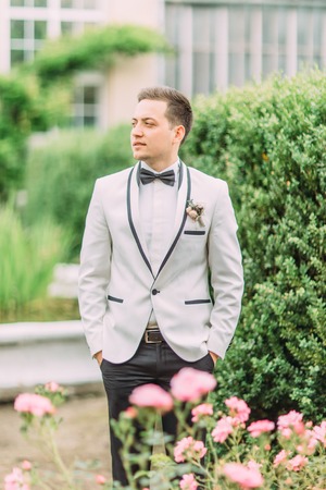 Half-length portrait of the groom looking aside. The garden location.の写真素材