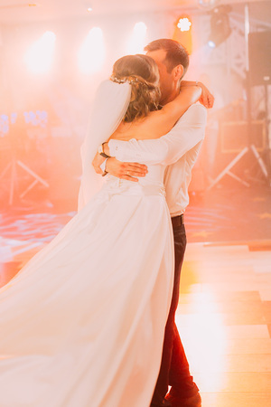 The groom is swaying the bride during the dance.の写真素材