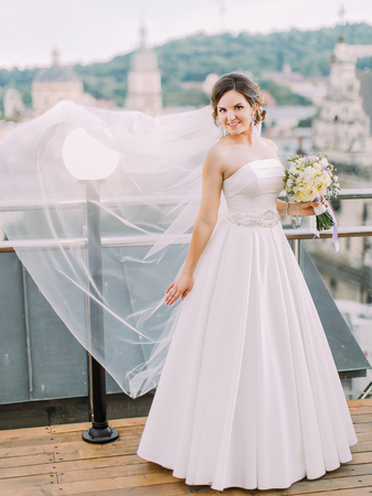The veil of the bride is overblowing. Full-length photo.の写真素材