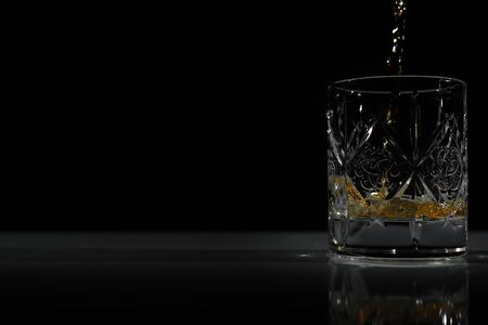 empty glass in which poured Scotch/whiskeyの写真素材
