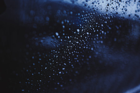 drops of water on the glass. cloudy rainy day. rain outside the window. blue texture background.
