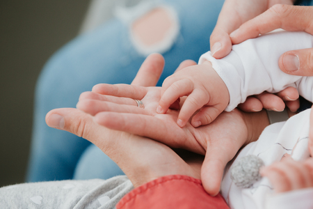 father and mother hold in their hands a little baby's.の写真素材