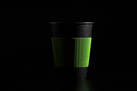 a glass of hot tea or coffee. Black paper glass with a lid on a black backgroundの写真素材
