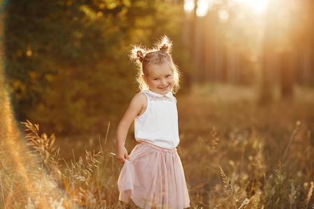 beautiful girl at sunset. children's portrait of a girl.の写真素材