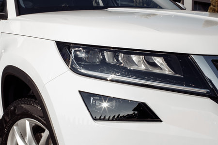 modern and elegant white car - Closeup of car headlight with copy space. white car headlight