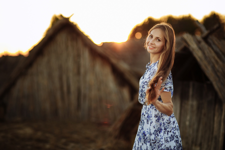 beautiful Young woman outdoors portrait. Portrait of a beautiful girl against a tree houseの写真素材