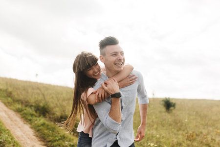Happy young couple hugging and laughing outdoors. Love and tenderness.Lifestyle concept.