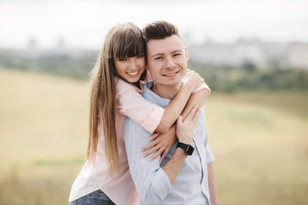 Happy young couple hugging and laughing outdoors. Love and tenderness.Lifestyle concept.