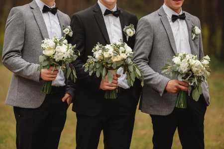Stylish groom are holding bridal bouquet. Wedding bouquet in man hands.