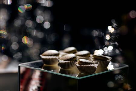 Chocolate macaroons cakes on a black background. Macaroons on black surface.の写真素材