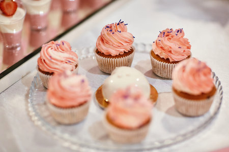 Set of different delicious tasty muffins on festive background. Different dessert tartlets with...