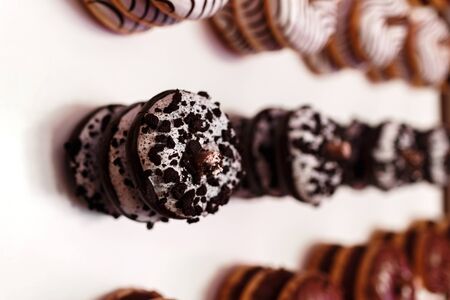 wedding chocolate donuts for guests. festive concept. sweets on a wedding day. wedding donuts. A yummy donut wallの写真素材