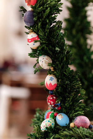 Easter eggs on Christmas tree. Easter background - colorful ester eggs hanging on fir tree
