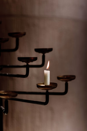 candle burns in the rustic candlestick.candle in church.