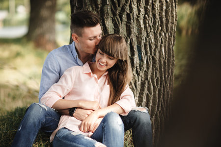 Loving young couple kissing and hugging in outdoors. Love and tenderness, dating, romance, family...