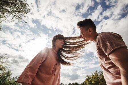 crazy young couple emotionally having fun, kissing and hugging outdoors. Love and tenderness, romance, family, emotions, fun. having fun togetherの写真素材