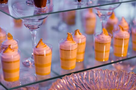 Candy bar on wedding ceremony with a lot of different modern desserts, cupcakes, sweets with fruits. Delicious candy bar. Catering Concept. selective focus.の写真素材