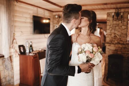 Bride and groom kiss at the first meeting. The first meeting of the bride and groom. First look of wedding couple in the morning. Wedding couple in the hotel. Bride and groomの写真素材