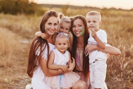 Big family is relaxing together in green nature. Mother's Day. happy family together. two moms with children. selective focus.の写真素材