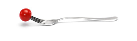 cherry tomatoes on a fork. isolated on a white background. Fork with cherry tomato close-up. Macro...