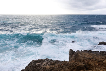 Waves hitting the rocky cliffs in a beach located in Cyprus,This weather might be dangerous for...