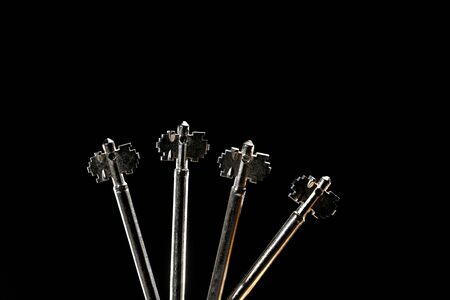 Four iron vintage keys isolated on black background. place for text. selective focusの写真素材