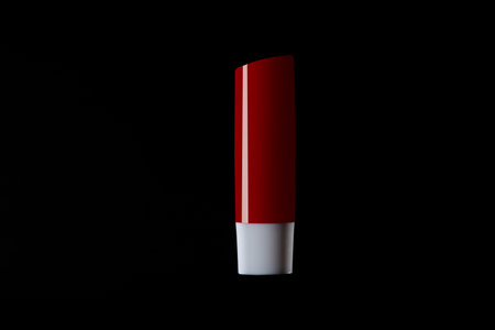 Red and white packoging lipstick isolated on Black background.