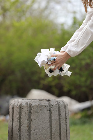 woman throws plastic garbage in the trash. woman hand picking up garbage plastic for cleaning at...