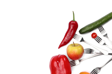 A healthy diet food. fresh cherry tomato, red pepper, cucumber, apple and orange fruits on forks on...