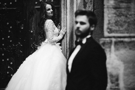 Wedding couple hugging in the old city. Blue vintage doors and cafe in ancient town on background....